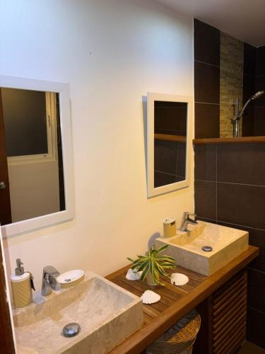 a bathroom with two sinks and a large mirror at Las Marías in El Morón