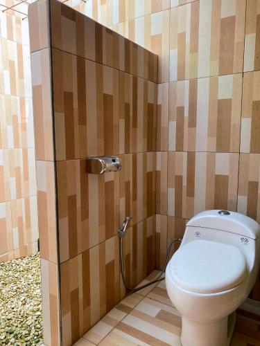 a bathroom with a toilet in a stall at Ghia Boutique Homestay in Batuangus