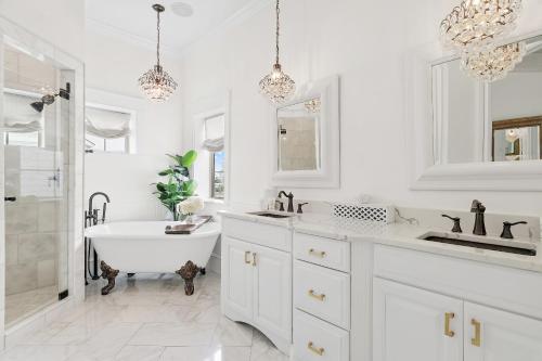 a white bathroom with a tub and a sink at 15 Mathis Cove in Inlet Beach