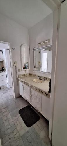 a bathroom with a sink and a large mirror at PlayaSol las Hadas in Manzanillo