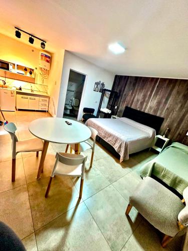 a bedroom with a bed and a table and chairs at Apart Piedras con cohera y desayuno seco in Villa María