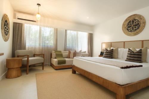 a bedroom with a large bed and a couch at Fiji Gateway Hotel in Nadi