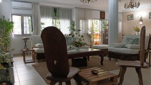 a living room with a table and a couch at Providence Guest house and Catering Services 01 in Abidjan