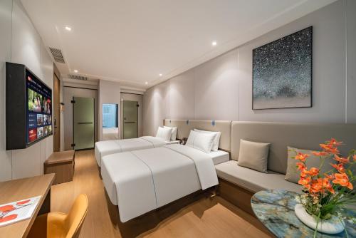 a hotel room with a bed and a couch at 德全m酒店 in Beijing