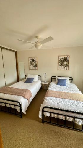 two beds sitting next to each other in a bedroom at The Deck @ VB - Linen, Wi-Fi, Pets, Secured Yard in Venus Bay