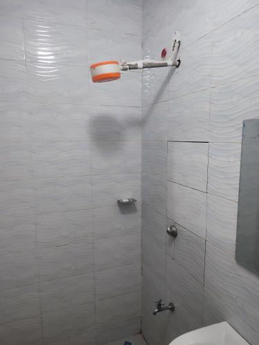 a bathroom with a shower with a toilet and a mirror at Harmony Haven in Rungiri