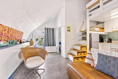 a living room with a couch and a chair at Binishell Igloo 6 - Famous Beachfront Dome with Pool in Trinity Beach