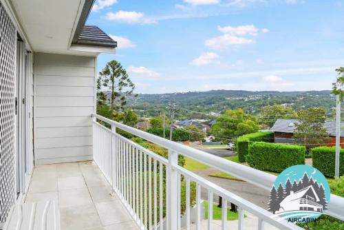 a balcony with a view of a city at 1B house beachside comfy stay in Collaroy