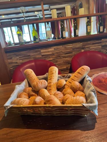a basket of bagels sitting on a table at Antico Mulino Hotel Garni in Todtmoos
