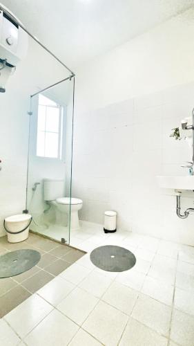 a bathroom with a glass shower and a toilet at Villa LA Mansion Lembang - 2BR for 2-6 Guest stay in Lembang