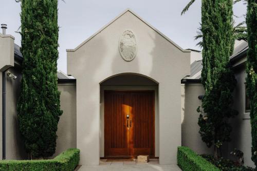 a white chapel with a brown door at The Retreat at Carrick Vineyard in Cromwell