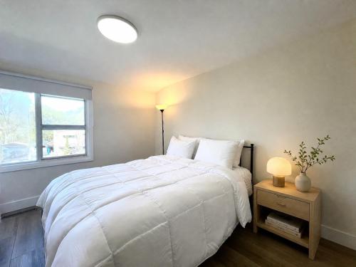 a bedroom with a large white bed and a window at ION House - Near Shopping Kennedy Station Easy Transit Downtown in Toronto