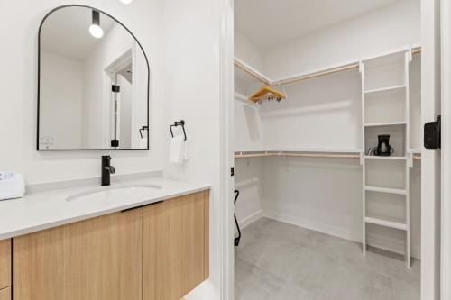 a bathroom with a sink and a mirror at The Code Hotel in Austin