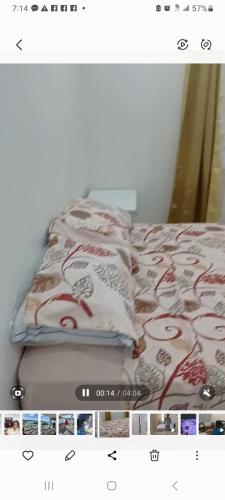 a picture of a bed with a blanket on it at Sunset Apartment in Grand Anse