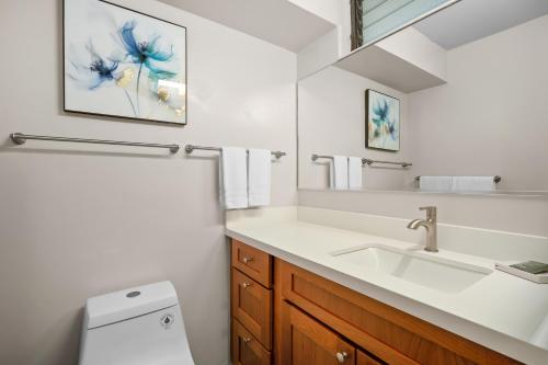 a bathroom with a sink and a toilet at Castle Po'ipū Shores in Koloa