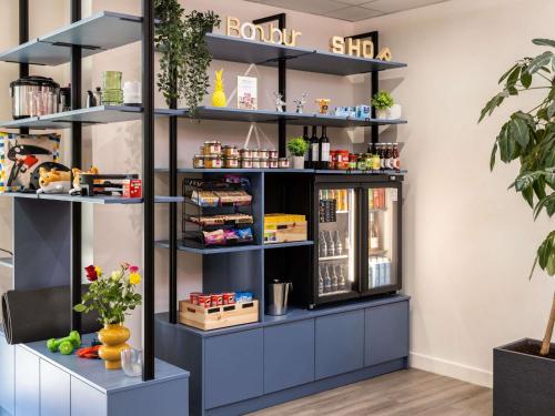 a shelf in a store with products on it at Aparthotel Adagio Access Toulouse Jolimont in Toulouse