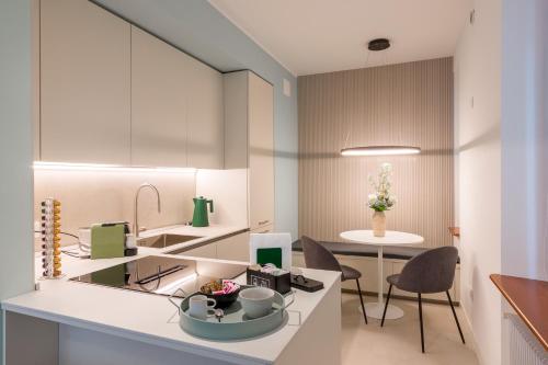a kitchen and dining room with a table and chairs at Alla Loggia in Udine