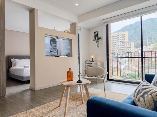 a living room with a couch and a bed and a table at Loft Design Centro Internacional Bogotá in Bogotá