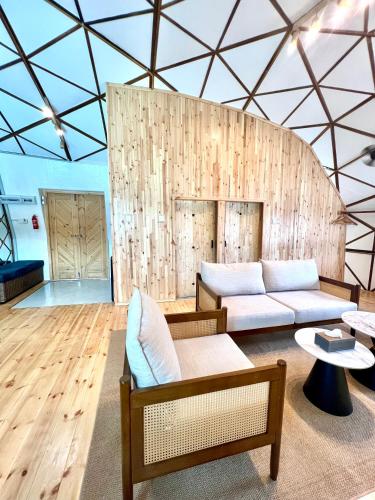 a living room with two couches and a table at Coconest THREE Langkawi in Tanjung Rhu