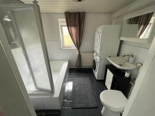 a small bathroom with a toilet and a sink at Ferienhaus Weitblick in Masserberg