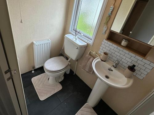 a small bathroom with a toilet and a sink at C43 The Hideout in Rowen