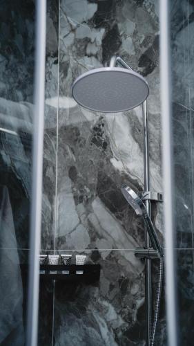 a shower in a room with a glass table at Jagalau in Balqash