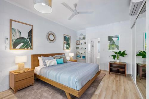 a bedroom with a king sized bed in a room at Trinity Charm - Beachside Family Getaway with Pool in Trinity Beach