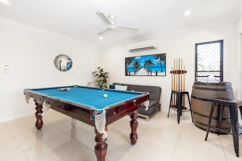 a living room with a pool table in it at Tropical Dreams - Spacious Retreat with Private Pool in Smithfield