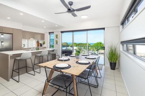 a kitchen and dining room with a table and chairs at Panorama Cairns - City & Coastal Views with Pool in Cairns