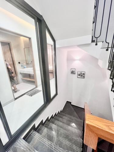 a staircase in a house with large windows at SunQ Haven in Meyhomes in Phú Quốc