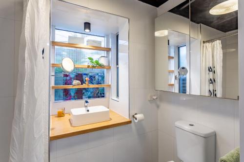a bathroom with a sink and a window at Studio 55 in Mudjimba