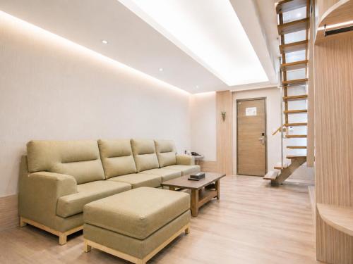 a living room with a couch and a table at Innk in Taichung