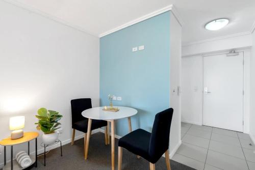 a dining room with a table and two chairs at McLeod Nook - Poolside Studio by Waterfront & Market in Cairns