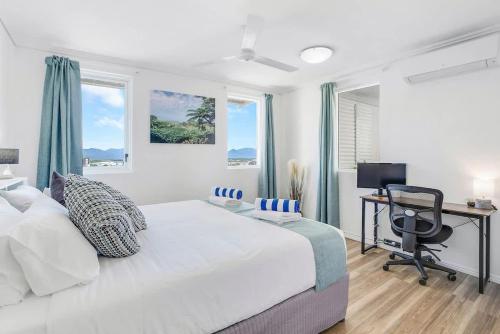 a bedroom with a bed and a desk with a computer at Cairns City Escape - Elevated Modern Haven with Pool in Cairns