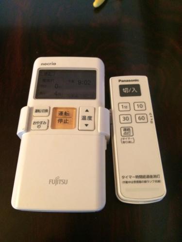 a remote control sitting on top of a table at Traveler's Wharf Shichigahama in Shichigahama