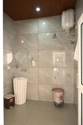 a bathroom with a shower and a toilet in it at Hotel Tela Suite Near IGI Airport Delhi in New Delhi