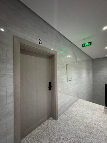 a door in a room with a sign on the wall at Modren AD 23 in Dammam