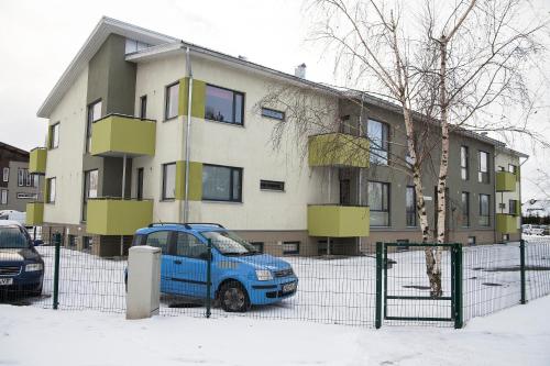 a blue van parked in front of a building at Modern Apartment in Tartu