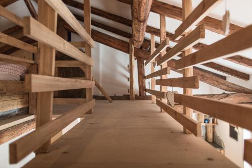a hallway in a building with wooden beams at Maso Del Fieno con Sauna Privata e Vista Unica in Sant'Orsola Terme