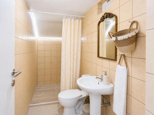 a small bathroom with a toilet and a sink at Studio Malades, Heraklion in Maládhes