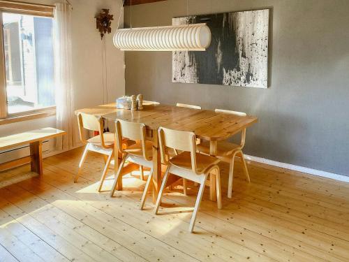 a wooden table and chairs in a dining room at Nature And Veranda In Perfect Alignment in Djurhamn