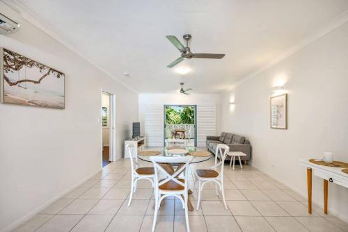 a living room with a table and chairs at Trinity Beach Bliss - Experience Tropical Living in Trinity Beach