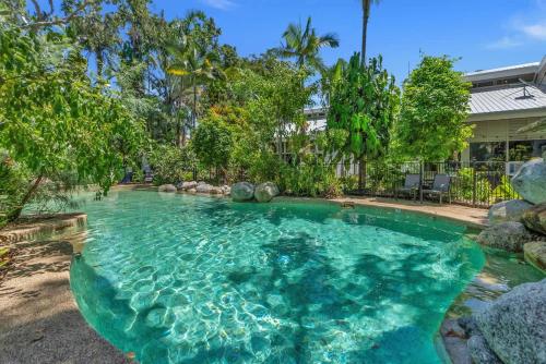 a swimming pool in the backyard of a house at Nirvana - Steps to Four Mile Beach with Shared Pool in Port Douglas