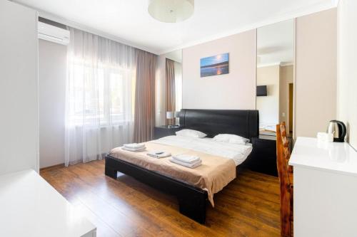 a bedroom with a bed and a mirror at Обійми Embrace in Truskavets