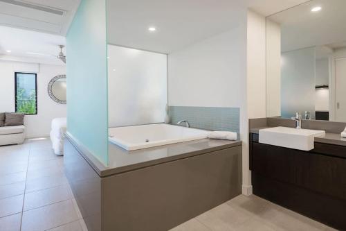 a bathroom with a large tub and a sink at 'Saltwater Studio' Experience Resort-style Bliss in Craiglie