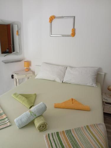 a large white bed with two pillows on it at The Palace Mattiazzi Room in Šibenik