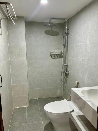 a bathroom with a toilet and a sink and a shower at Han House's Apartment in Danang