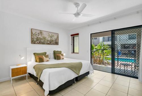 a bedroom with a large bed and a balcony at Laguna Edge - Swim-Out Studio, near Sea & Dining in Trinity Beach