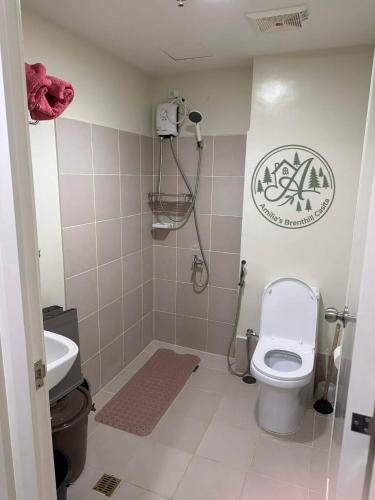 a bathroom with a toilet and a sink at Unit 208 Venus Transients-Brenthill in Baguio