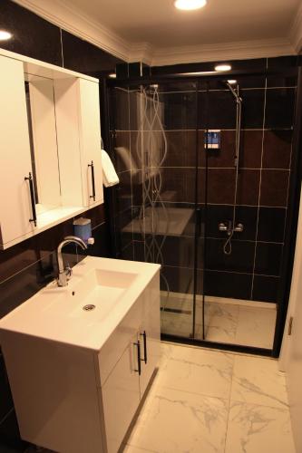 a bathroom with a sink and a shower at Çamlıca Tower Hotel in Istanbul